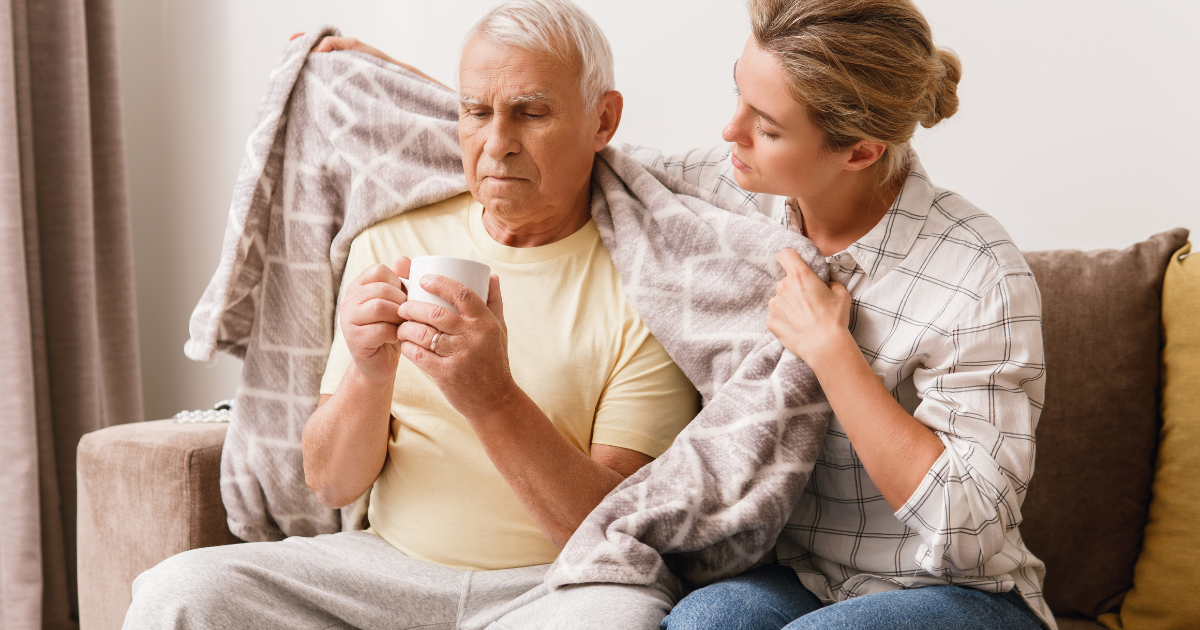 Caregiver helping senior in preventing cold and flu