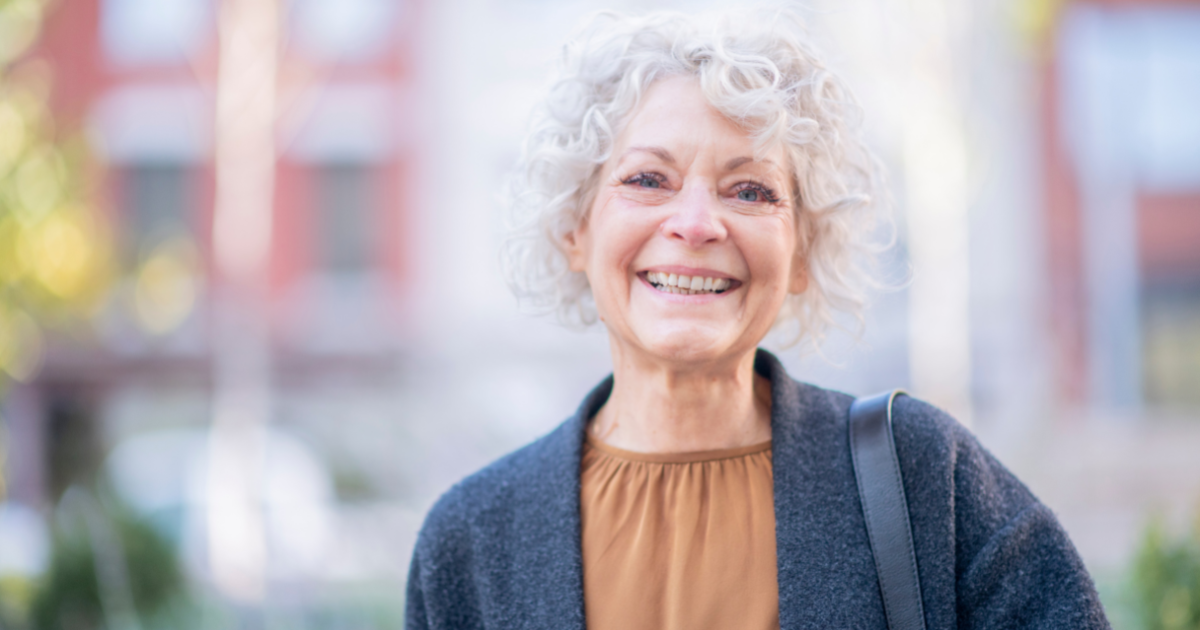A woman is happy as a result of successfully managing senior incontinence.