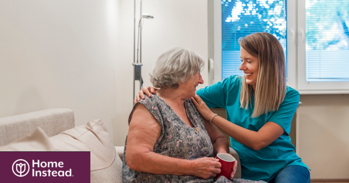 A home care provider compassionately tends to a senior client in their home.