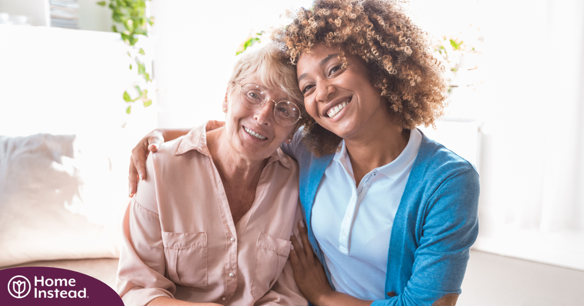 A caregiver enjoys professional caregiving as she helps a senior client.